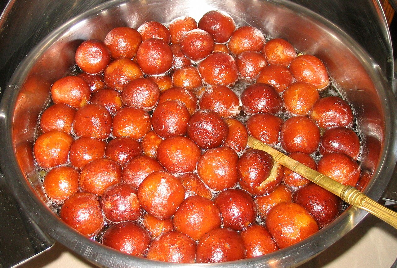 Gulab jamun, golden fried milk dumplings in rose syrup