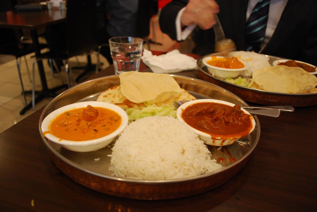 Indian thali spread with curries, rice and bread