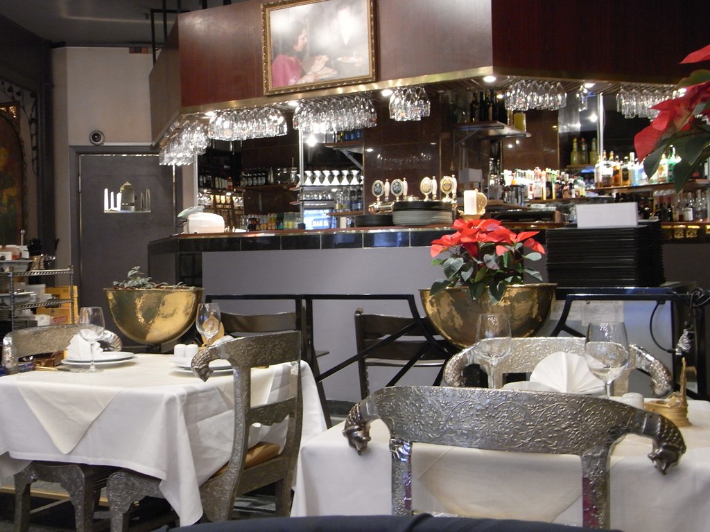 Warm restaurant dining room with set tables