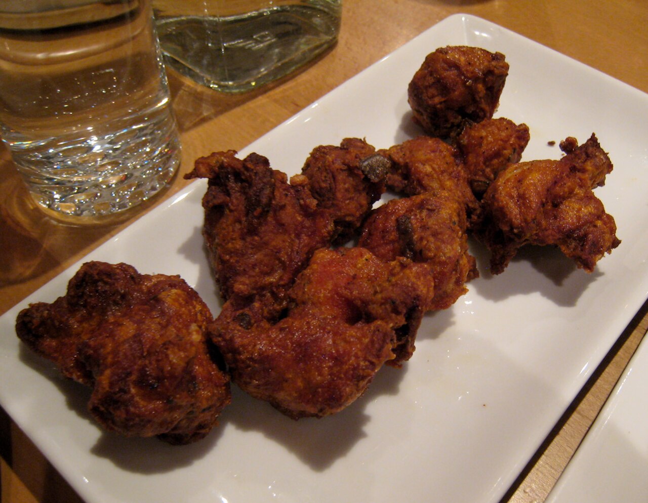 Chicken 65, crisp red fried chicken pieces with curry leaves