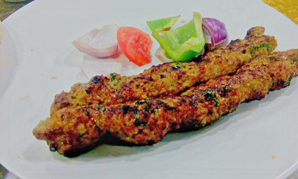 Seekh kebab, long minced meat skewers charred on the grill